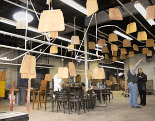 small wood shop uses overhead conveyor