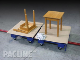 Towline conveyor with rotating top that allows access to all sides of furniture piece through assembly process.
