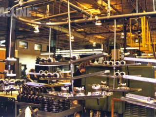 Overhead conveyor with double decker carriers for assembly of appliance motors.