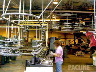 PAC-LINE ceiling mounted overhead conveyor system showcasing assembly of electronic parts.