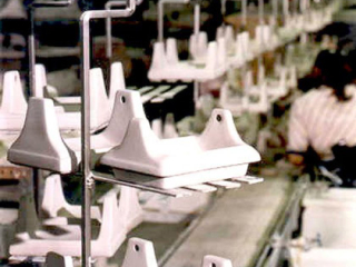 Custom made carriers on a PAC-LINE assembly line conveyor that carries ceramic molded parts.
