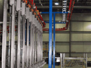 Automotive parts are transferred between assembly operations using the PACLINE&#039;s power and free conveyor.