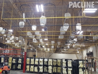 Overhead conveyor for transporting foam headrests in an automotive assembly plant