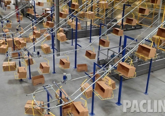 Box conveyor system for large distribution center. Delivers empty cartons from carton erector to packing areas.