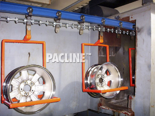 I beam monorail conveyor with custom carriers to transport wheel rims though chemical wash process.