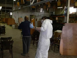 Sanding is done while parts are hanging on a monorail conveyor.
