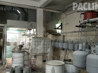 PAC-LINE™ enclosed track conveyor for refurbishing propane tanks.