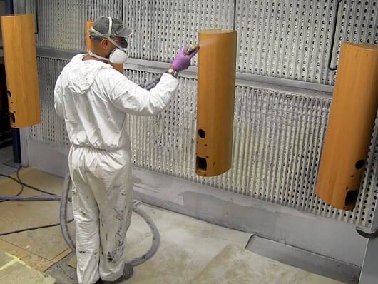 Conveyors handle wood furniture items through paint finishing processes
