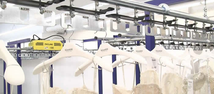 Dresses on garment handling conveyor