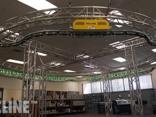 PAC-LINE™ enclosed track conveyor for a drone creative display system.