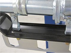 Dust shields for garment conveyors to catch debris from falling onto garments.