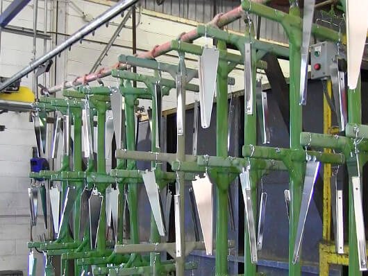 Overhead conveyors for metal finishing processes including electrocoating and electroplating.