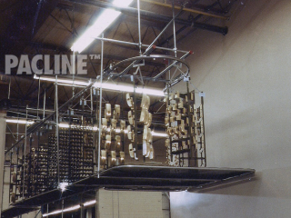 Overhead conveyor system handles commercial door parts through electroplating process.
