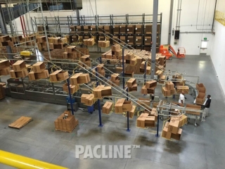 Empty box conveyor for large warehouse utilizing overhead space.