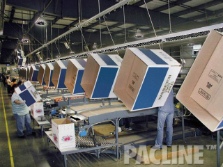 The PAC-LINE™ enclosed track conveyor system is used to convey empty cartons over the apple packing area.