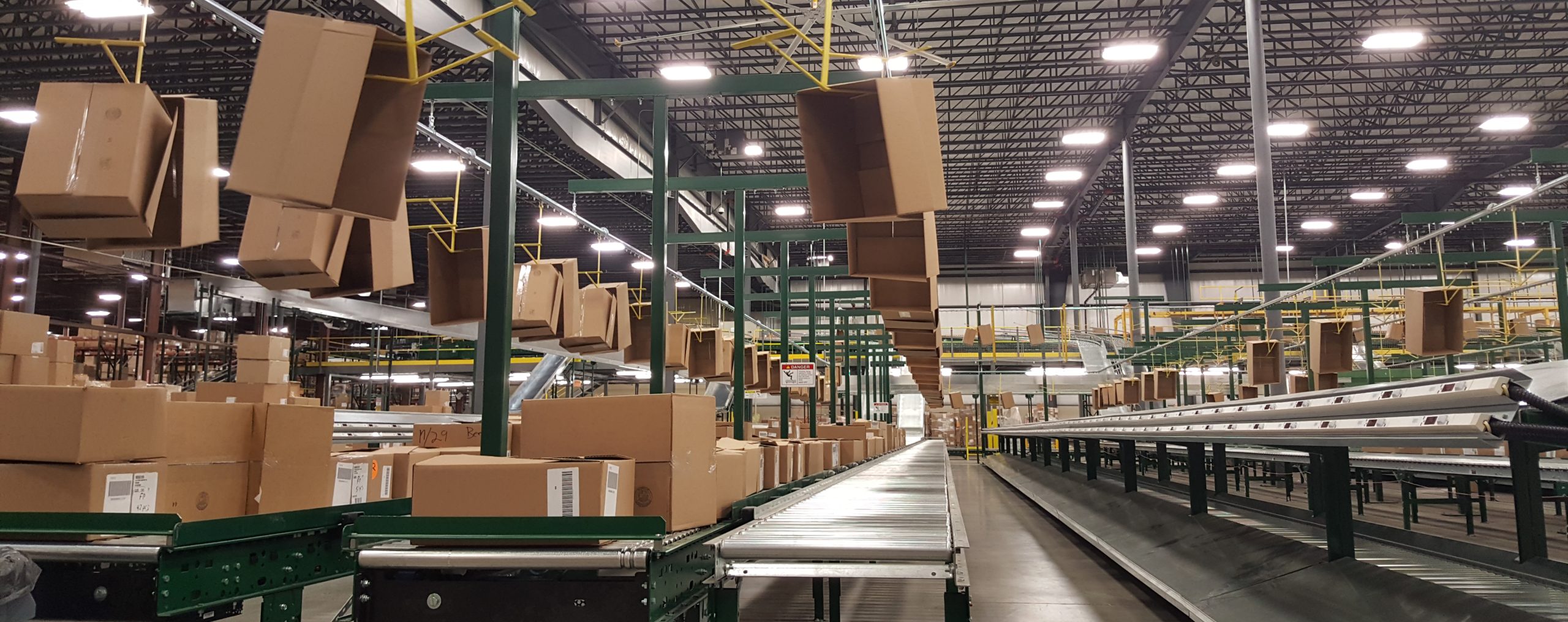 Why overhead monorails are the best for empty carton induction in distribution centers and warehouses