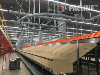 Empty tote conveyor project in a retail Distribution Center.  Approximately 1300 feet long, delivering totes to operators.