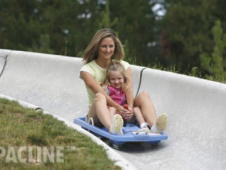 Family enjoys alpine sleds at Winter Park Colorado. Our conveyor is used to accumulate and deliver sleds to patrons.