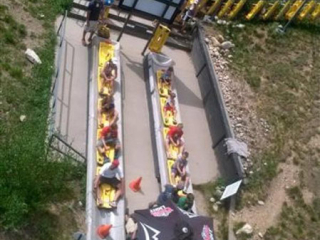 Pacline&#039;s enclosed track overhead conveyor is used to accumulate and carry alpine sleds to riders.