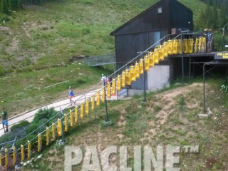 Alpine sleds being conveyed uphill by The PAC-LINE™ enclosed track overhead conveyor to waiting patrons.