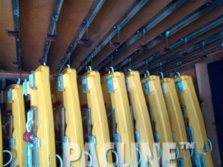PACLINE overhead conveyor accumulates and delivers alpine sleds to patrons in a recreational facility.