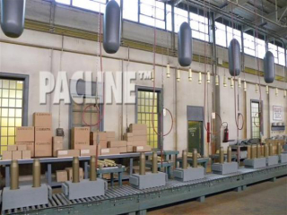 The PAC-LINE enclosed track overhead conveyor carries munitions on an assembly line in this Bomb Girls movie set.