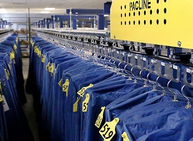 Full length garment bags can be handled in compact areas with an overhead conveyor system.