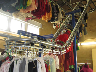 Hundreds of clothing items are cataloged and organized for easy, quick retrieval with PACLINE&#039;s automatic storage and retrieval conveyor.