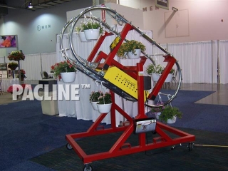 Demonstrates the functionality and versatility of the enclosed track system for handling hanging plants.