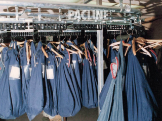 Automated garment retrieval system in detention centre handles inmate property storage bags of various weights and sizes.