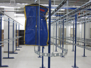 single track, PACLINE conveyor with carriers designed to double the capacity for storing full length garment bags.
