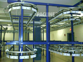 High density garment storage and retrieval conveyor can handle up to 100 lbs. per two-pendant rack.