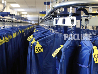 Enclosed track conveyor system for handling inmate property garment bags in correctional center.