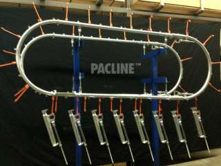 Over-under gravity assisted conveyor for transferring parts between single load and unload points.