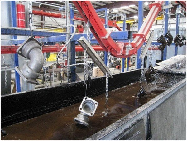 Overhead conveyor for heavy loads through a wet paint dip line.