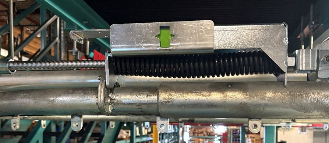 Chain Tension Indicator window located on the take-up assembly expansion unit for the PAC-LINE™ enclosed track overhead conveyor system.