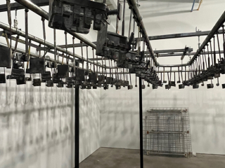 Pacline overhead conveyor for painting hockey sticks