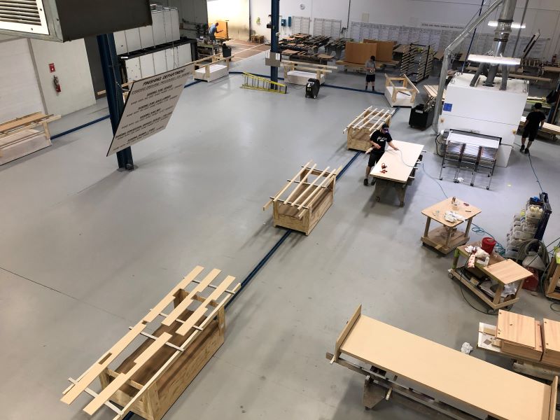 wood parts being carrying on a towline conveyor