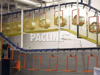 Pacline I-beam conveyor used to transport wheel rims through wash process before electroplating.