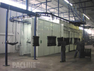 A 4 inch I-beam overhead conveyor used in wet spraying of heavy truck suspension components.