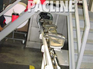 An automotive finishing line uses a PAC-MAX enclosed track conveyor to transport light bezels into a spray booth.
