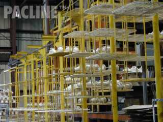 Finishing of pipe fittings on multi-tiered carrier using The PAC-LINE™ enclosed track conveyor.