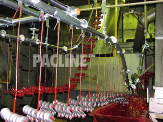 The PACLINE enclosed track conveyor. Dip paint finishing of lifting hooks in confined area with steep elevation.