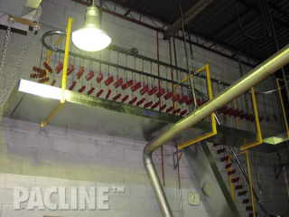 The PAC-LINE™ overhead conveyor with sheet metal guarding for small parts and to catch any paint drippings.