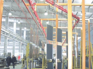 Powder coating of safe components using long load bars and bias banking for storage, S-310 Power and Free conveyor.