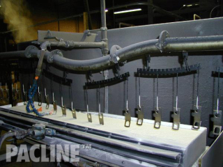 The PAC-LINE™ overhead conveyor system dip coating through liquidized bed for seat belt components.