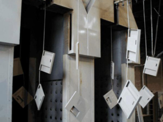 Powder coating of storage locker components on The PAC-LINE™ overhead conveyor system.