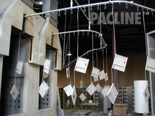 The PACLINE overhead conveyor is perfect for this powder coating application on storage locker components.