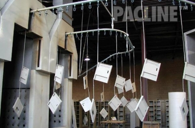 The PACLINE overhead conveyor is perfect for this powder coating application on storage locker components.
