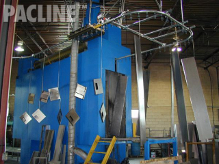 Locker storage components get powder coating treatment while on an overhead conveyor system.
